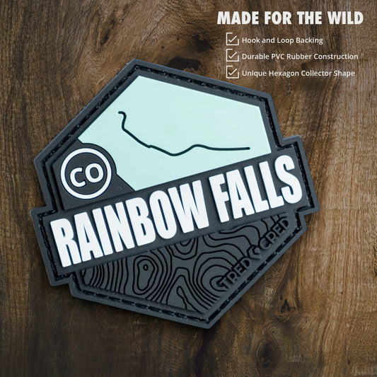Tred Cred Rainbow Falls hexagon PVC patch with hook and loop backing on a wooden background