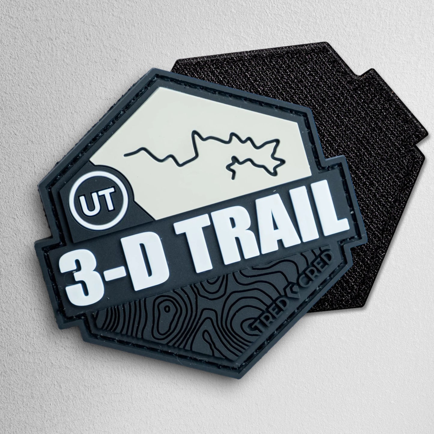 Tred Cred 3-D Trail hexagonal PVC rubber patch with Utah topography map and hook and loop backing.