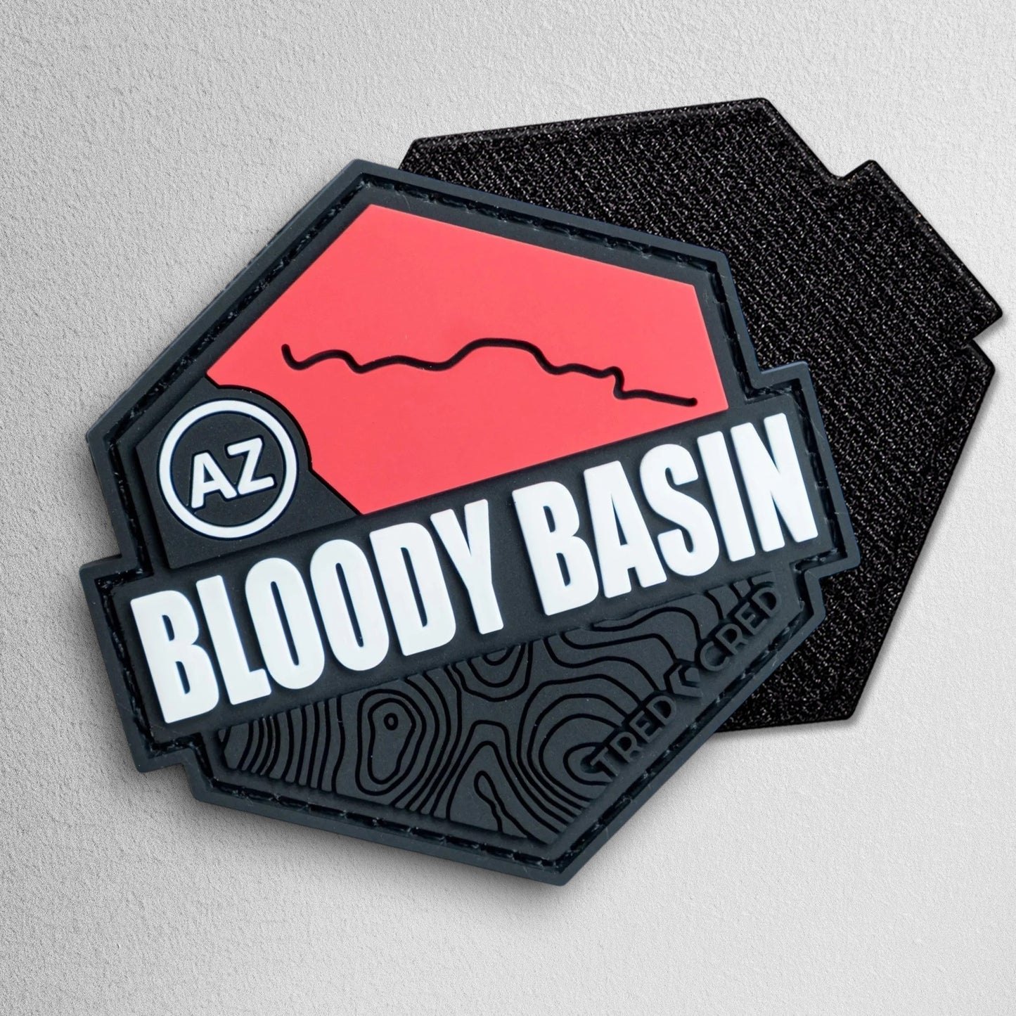 Tred Cred Bloody Basin hexagonal PVC trail patch in red and black with AZ Arizona map detail and hook backing.