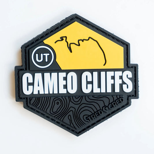 Tred Cred Cameo Cliffs hexagonal PVC trail patch in yellow and black with topographic map details and UT label.