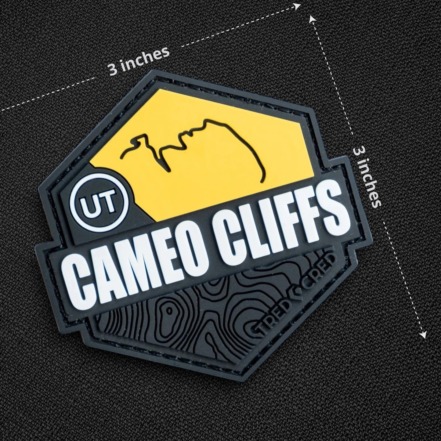 Tred Cred Cameo Cliffs PVC trail patch with yellow and black topographic design and hook and loop backing