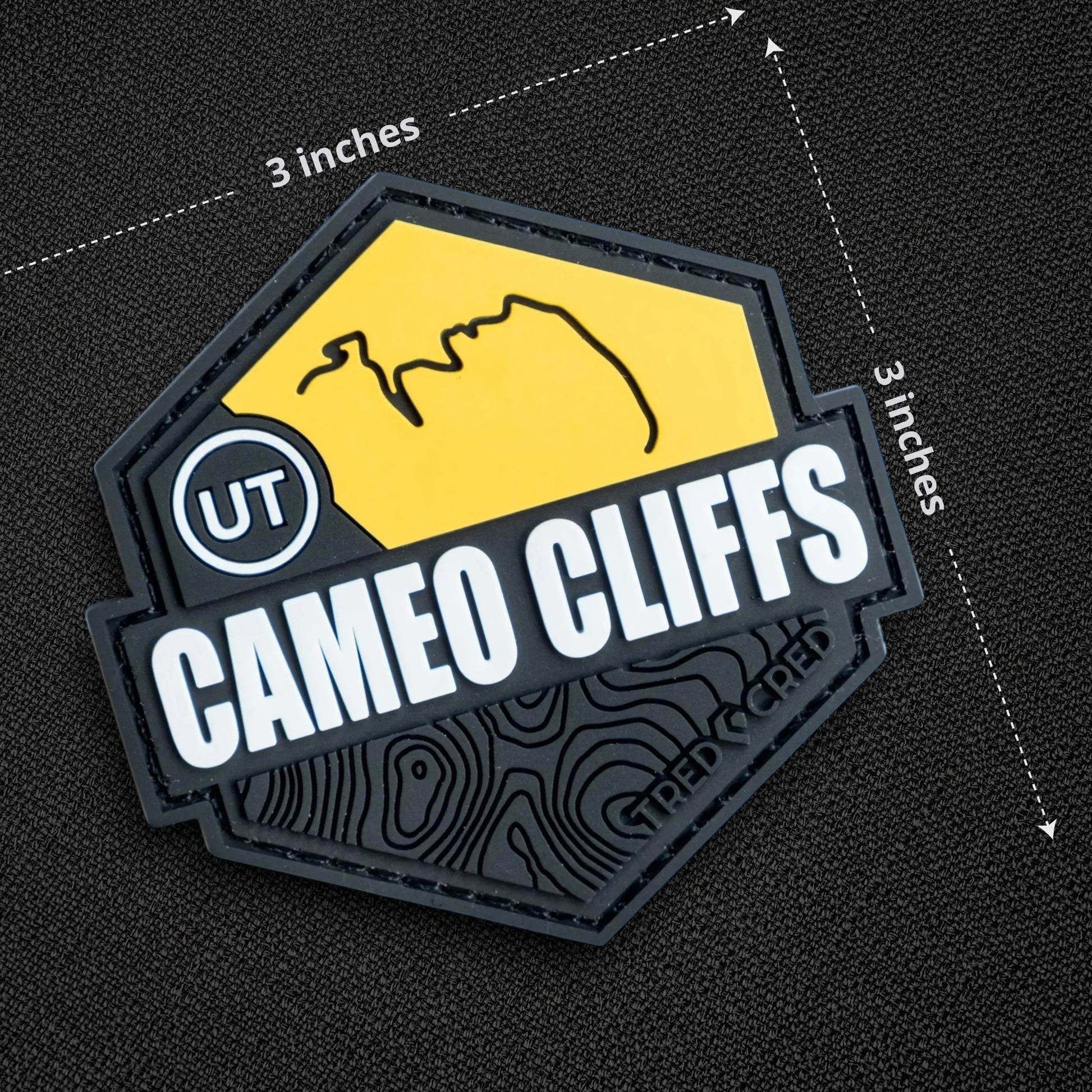 Tred Cred Cameo Cliffs PVC trail patch with yellow and black topographic design and hook and loop backing