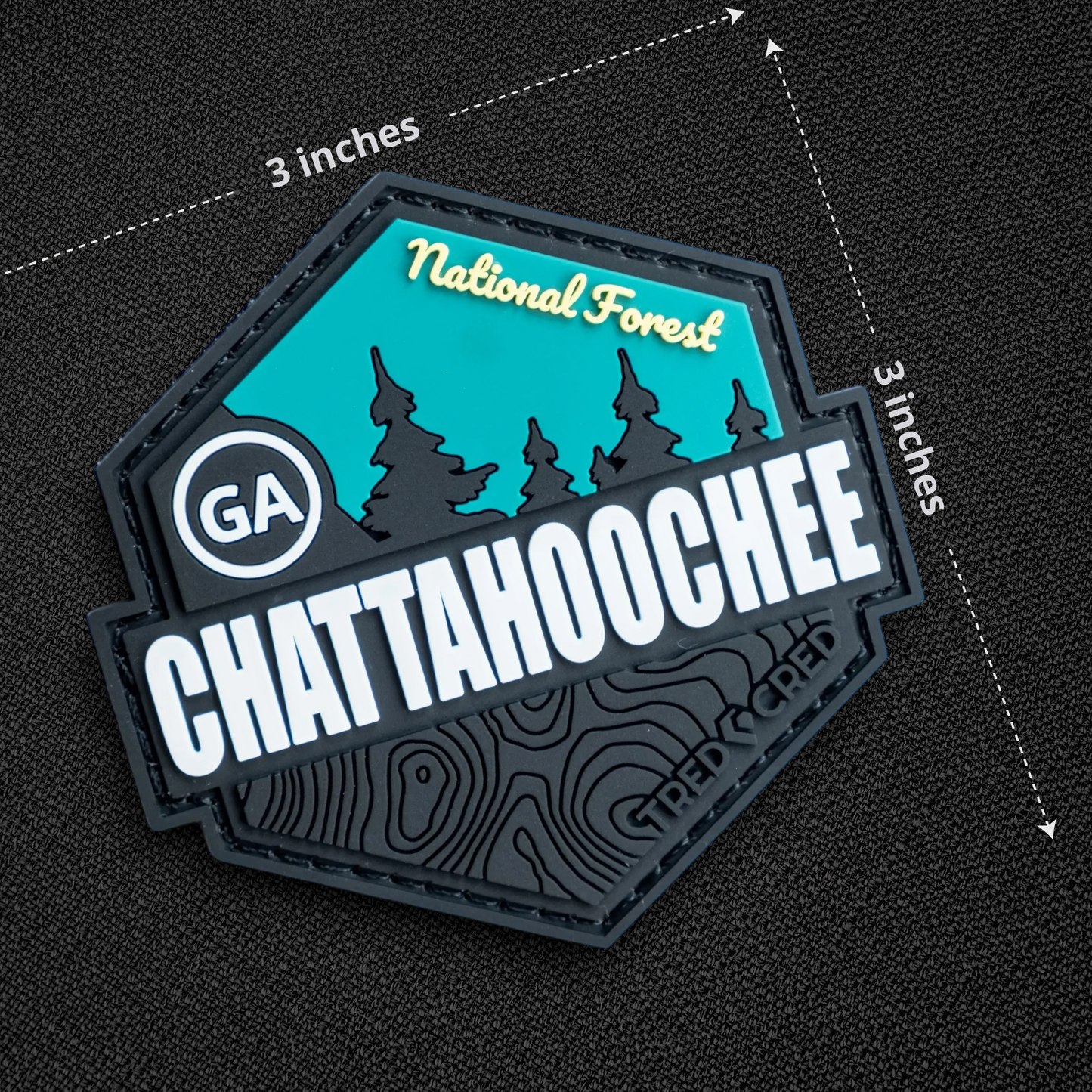 Tred Cred Chattahoochee National Forest PVC patch with teal and black topographic design and hook backing.