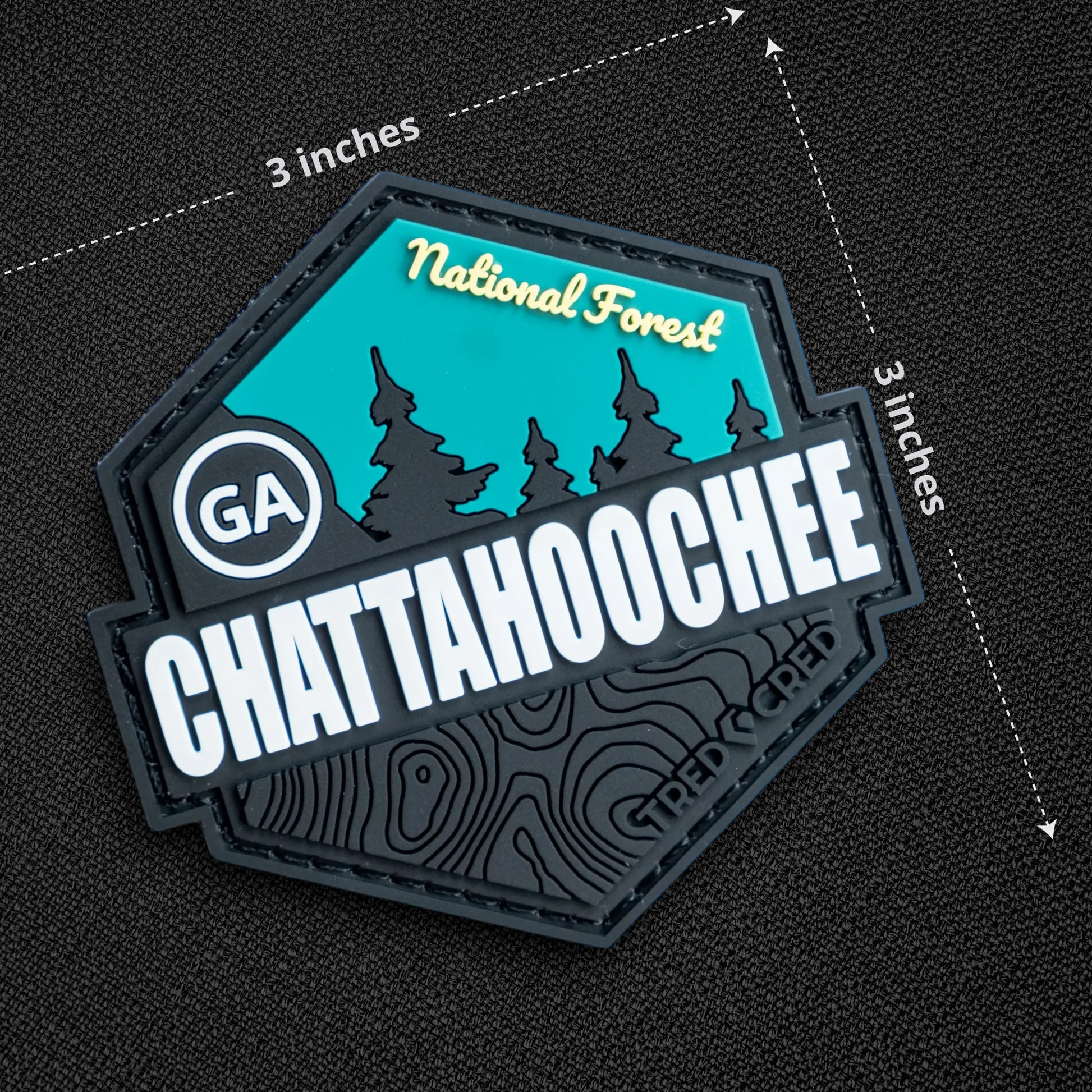 Tred Cred Chattahoochee National Forest PVC patch with teal and black topographic design and hook backing.