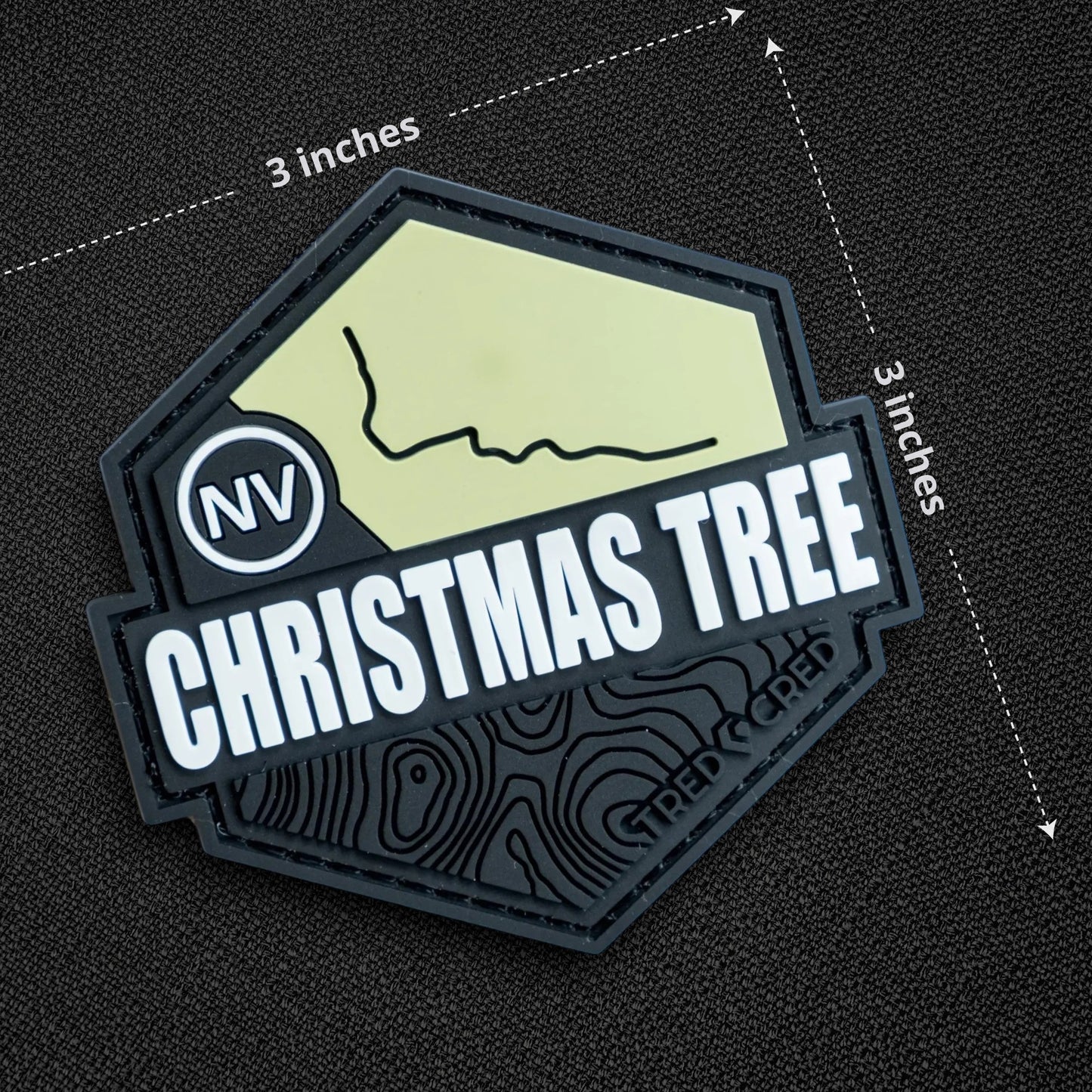 Tred Cred Christmas Tree Pass trail patch, a 3x3 inch hexagonal PVC rubber badge with hook and loop backing.