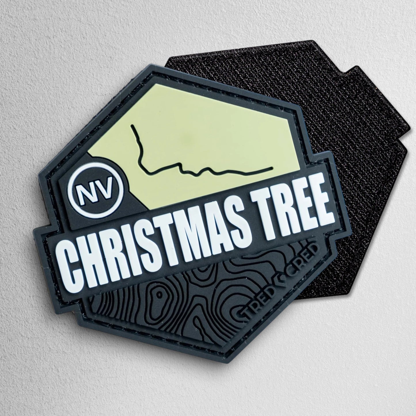 Tred Cred Christmas Tree Pass PVC trail patch with Nevada map, topographic lines, and hook and loop backing.
