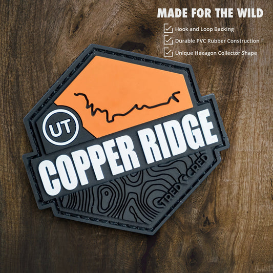 Tred Cred Copper Ridge PVC trail patch with orange and black topographic design and hook and loop backing