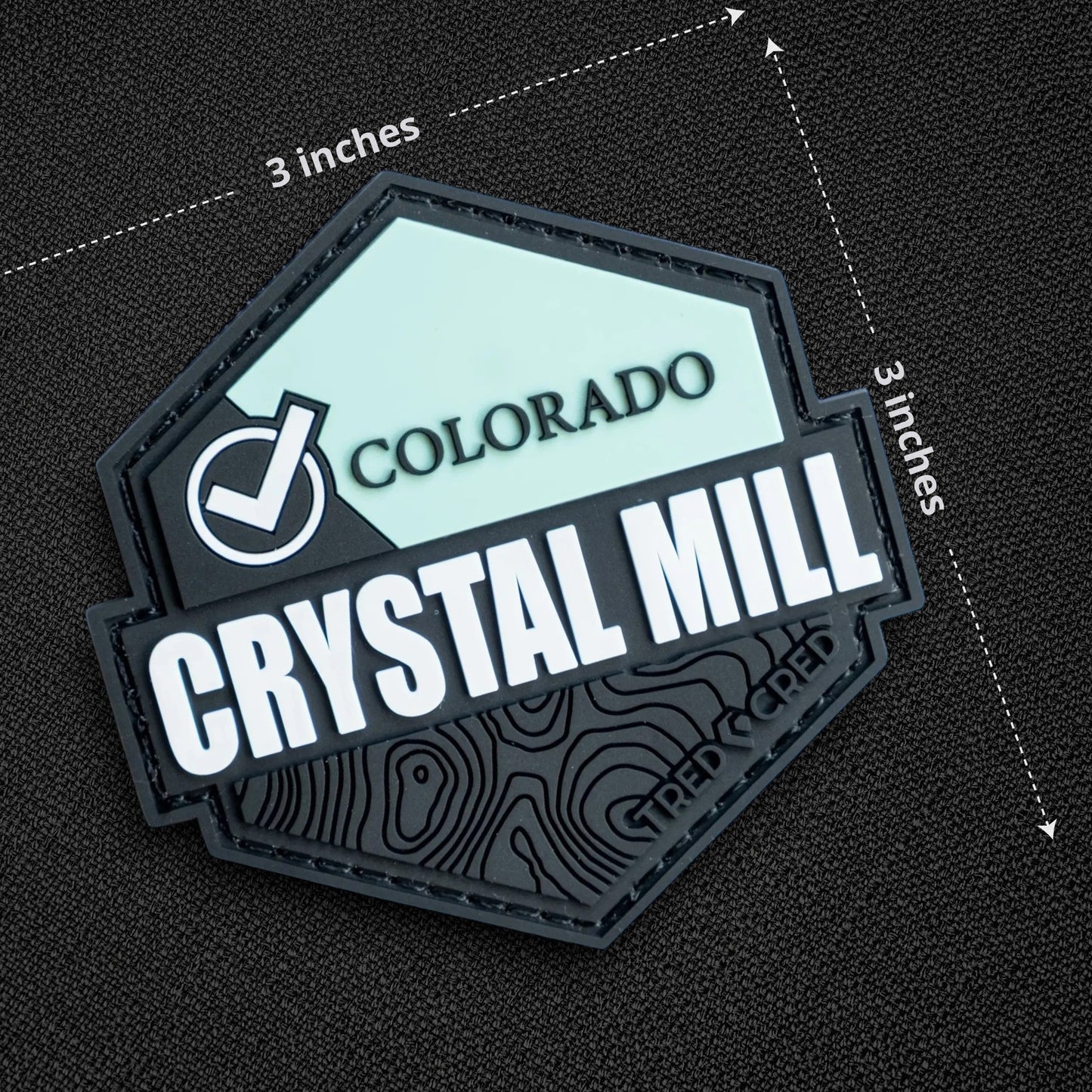 Tred Cred Crystal Mill PVC patch with Colorado branding and topographic map design on a black textured background.