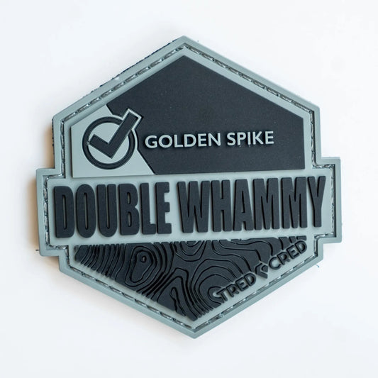 Tred Cred Double Whammy PVC rubber trail patch with a hexagonal shape, topographic map design, and hook backing.