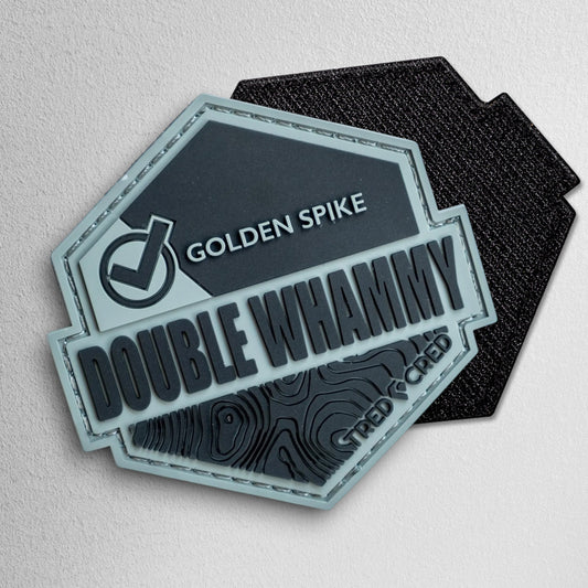 Tred Cred Double Whammy hexagonal PVC trail patch in grey and black with topographic map detail and hook backing