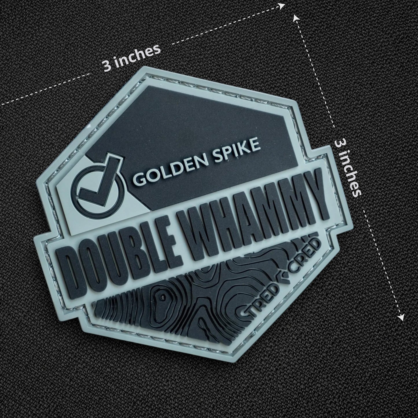 Tred Cred Double Whammy 3x3 inch PVC rubber trail patch with topographic map design and hook and loop backing.