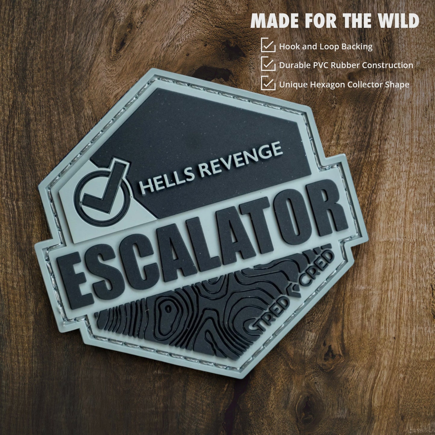 Tred Cred Escalator hexagon trail patch made of durable grey and black PVC rubber with hook and loop backing.