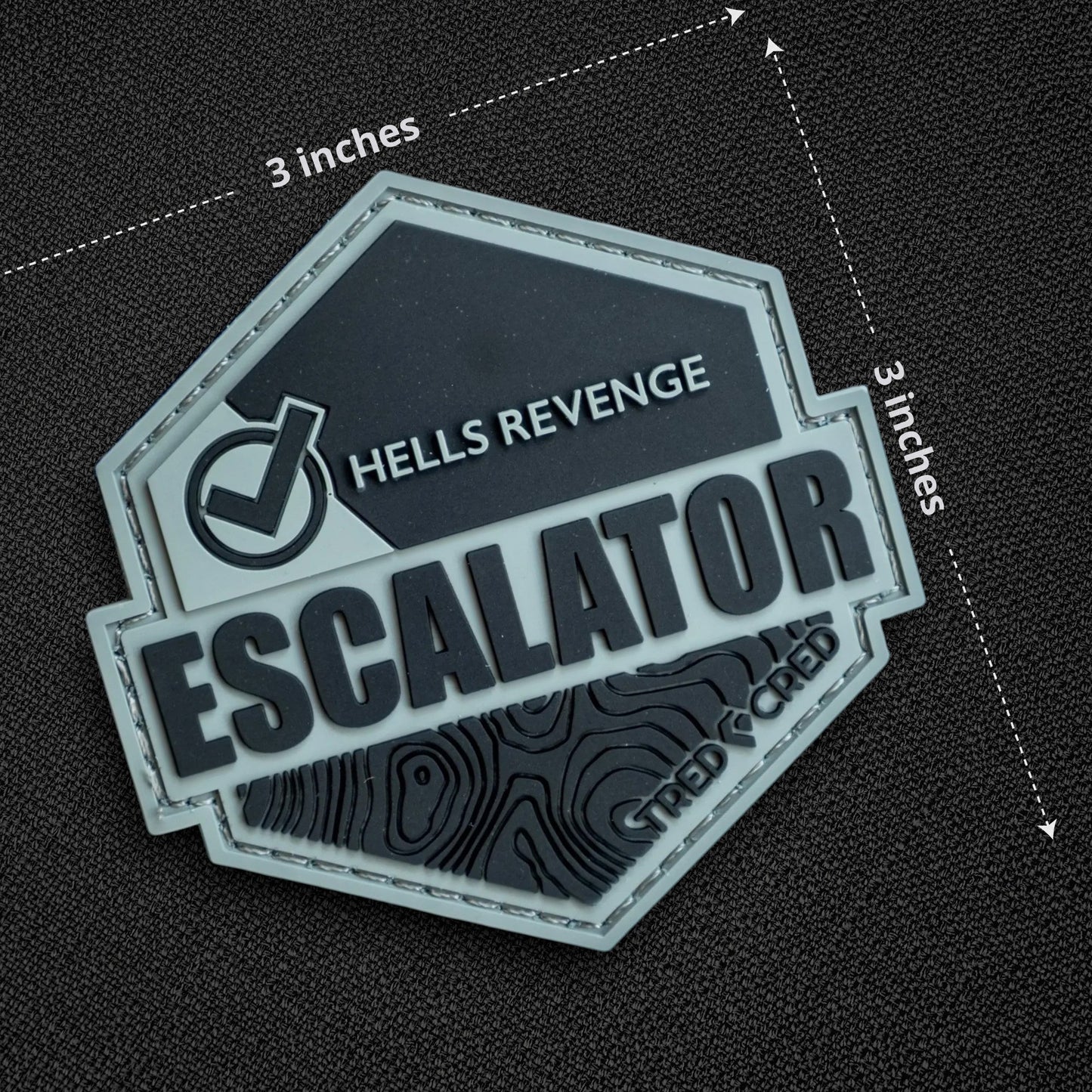 Tred Cred Escalator trail patch in grey and black PVC rubber with Hells Revenge text and topographic map design