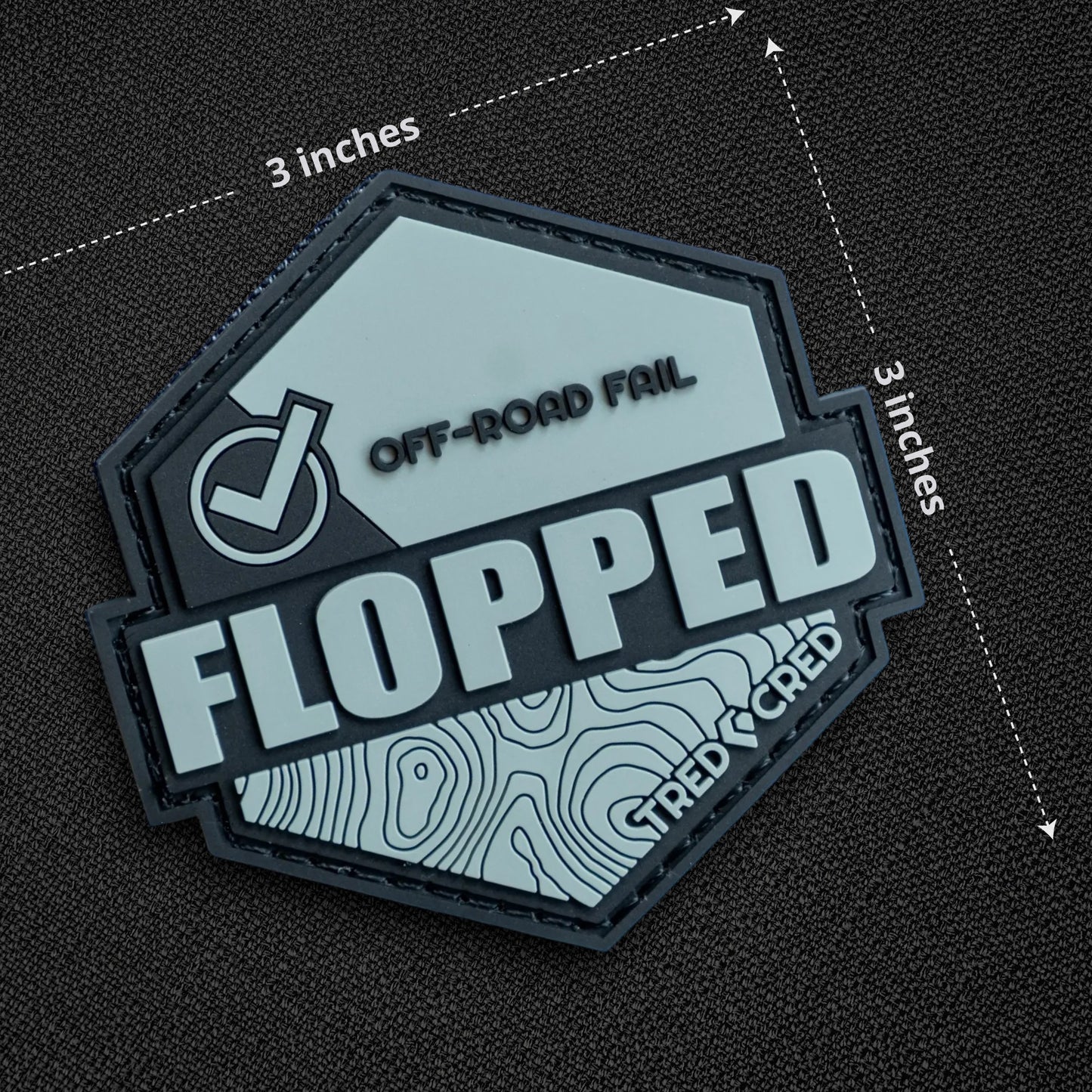 Tred Cred Flopped hexagonal PVC patch with off-road fail text, topographic map design, and hook and loop backing.