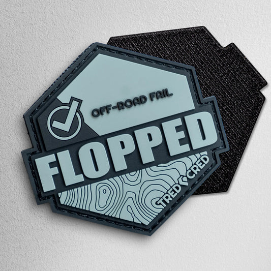Tred Cred Flopped PVC patch in grey and black with a hexagonal shape, topographical design, and hook and loop backing.
