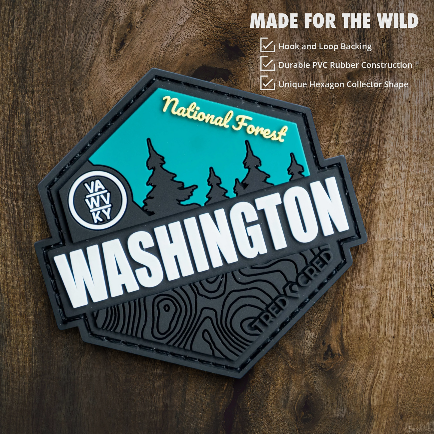 Tred Cred George Washington National Forest hexagon PVC patch with teal and black design on a wooden background
