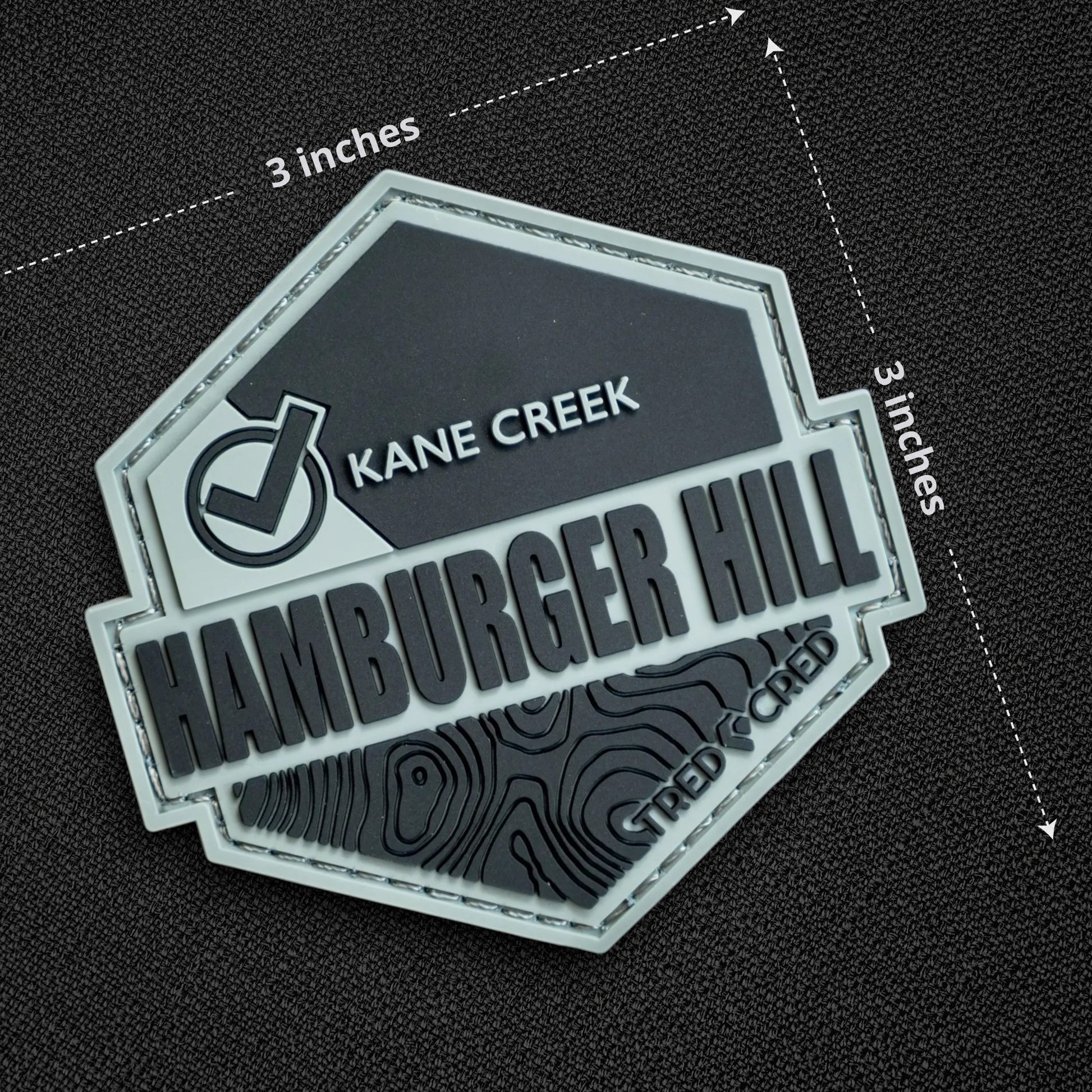 Tred Cred Hamburger Hill PVC trail patch with topographic map design and hook and loop backing