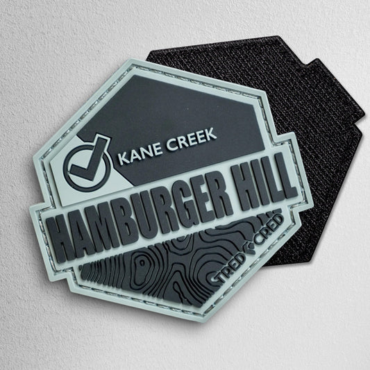 Tred Cred Hamburger Hill PVC rubber trail patch with topographic map design and hook and loop backing