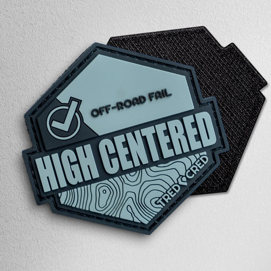 Tred Cred High Centered hexagonal PVC patch in grey and black with off-road fail graphic and hook backing.