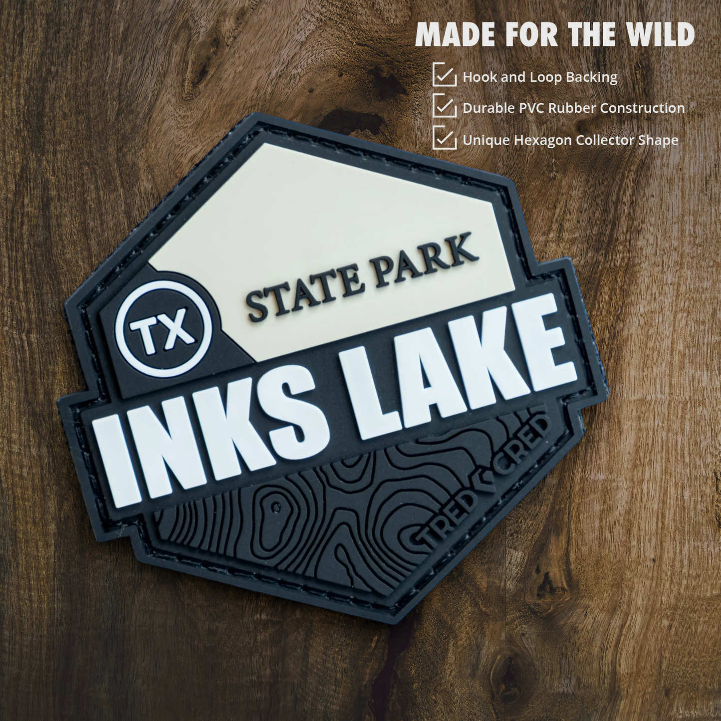 Tred Cred Inks Lake State Park hexagonal PVC patch with hook and loop backing on a wooden background