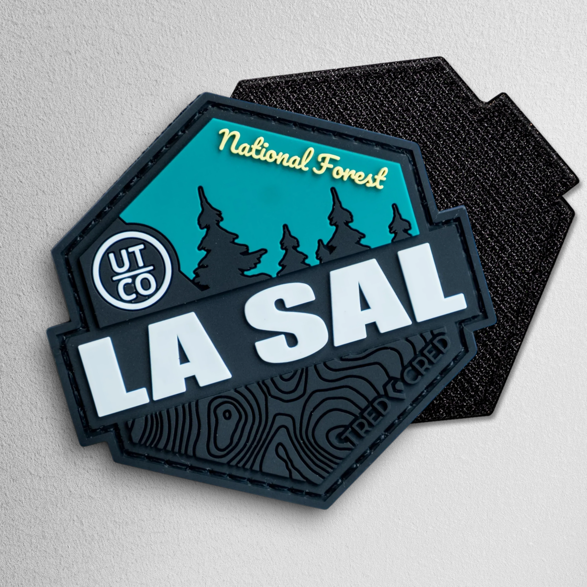 Tred Cred La Sal National Forest PVC patch with teal and black topographic design and hook and loop backing.