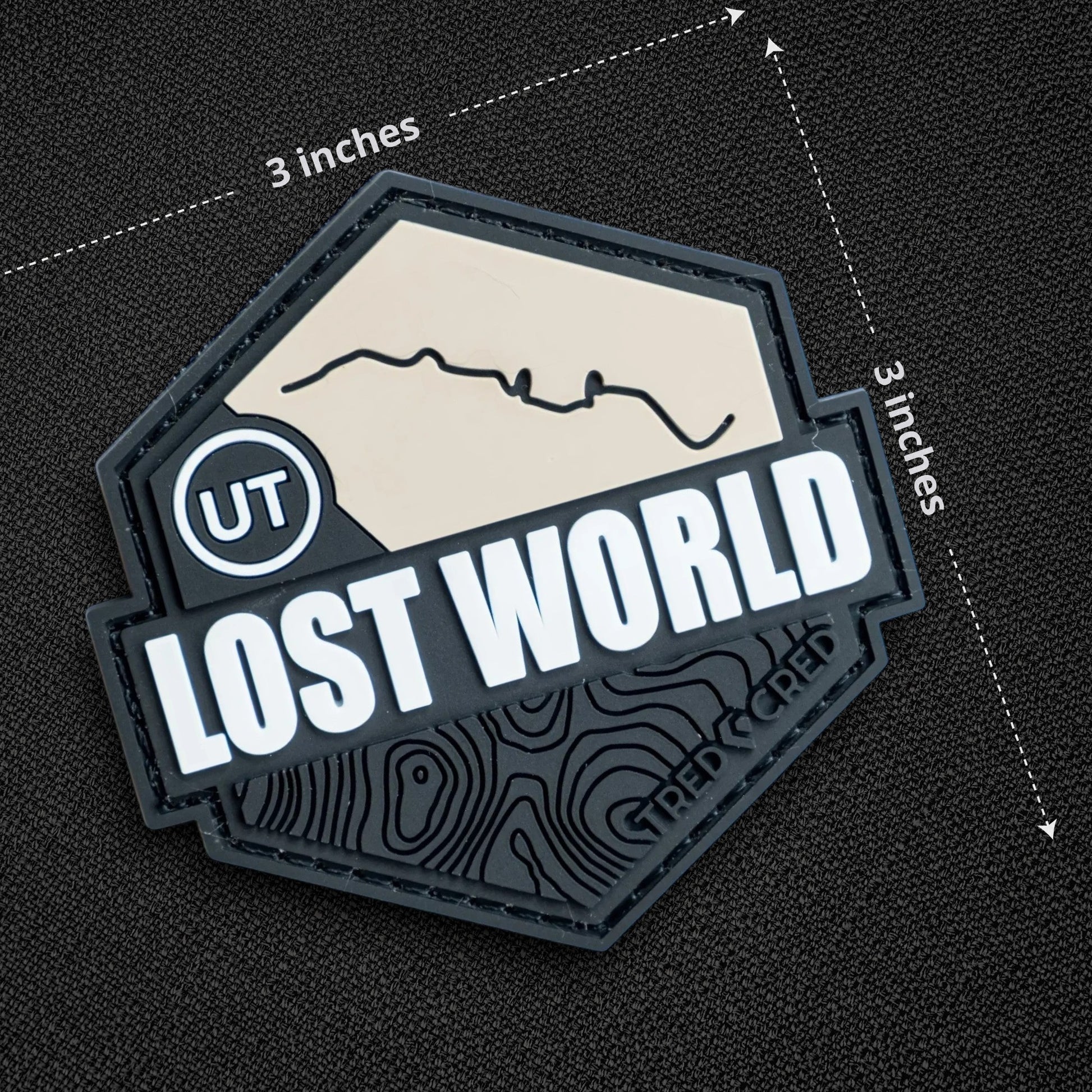 Tred Cred Lost World 3x3 inch PVC rubber trail patch with topographic map design and hook and loop backing