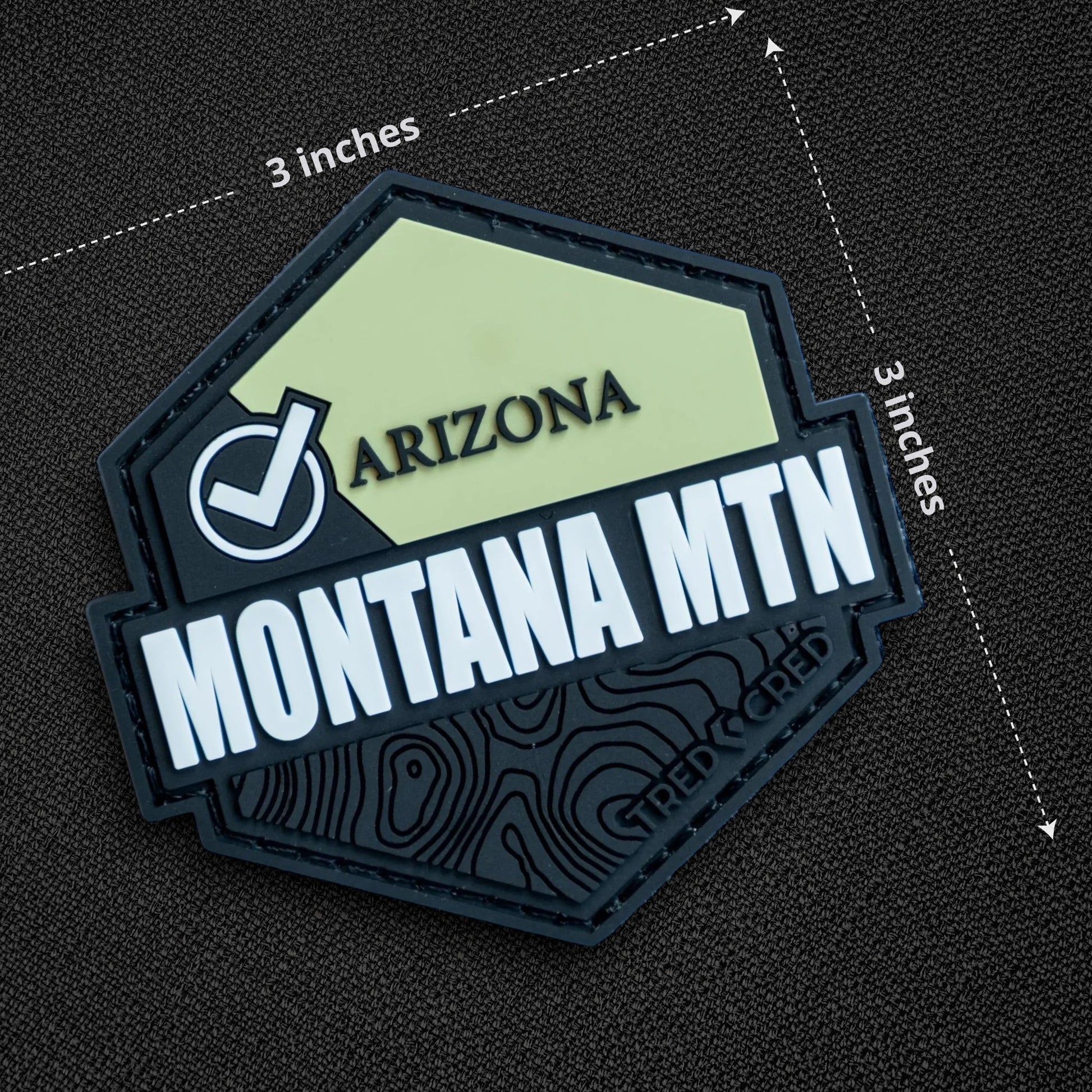 Tred Cred Montana Mountain PVC patch with a hexagonal shape, light green and black design, and hook and loop backing.