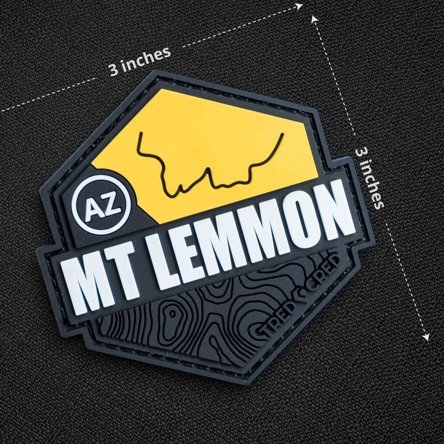Tred Cred Mount Lemmon PVC patch with yellow and black topographic design and hook and loop backing.