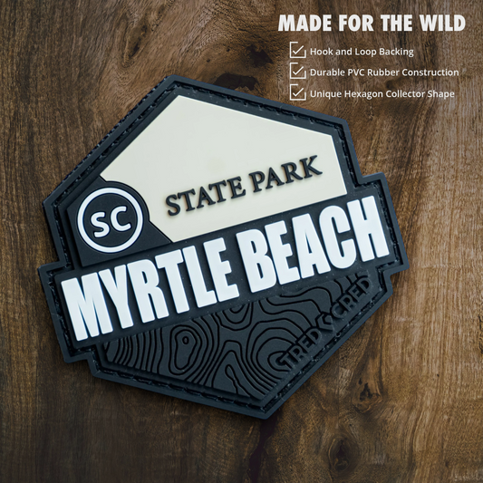 Tred Cred Myrtle Beach State Park hexagonal PVC patch with hook and loop backing on a wooden background