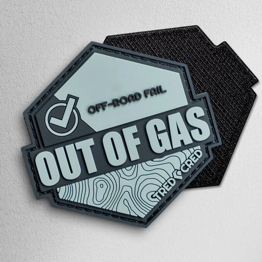 Tred Cred Out of Gas hexagonal PVC patch in grey and black with topographic map design and hook and loop backing.