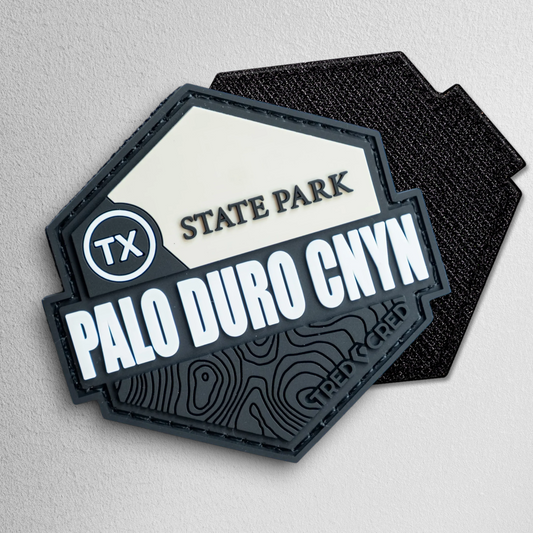 Tred Cred Palo Duro Canyon State Park PVC patch with black and cream topographic design and hook and loop backing.