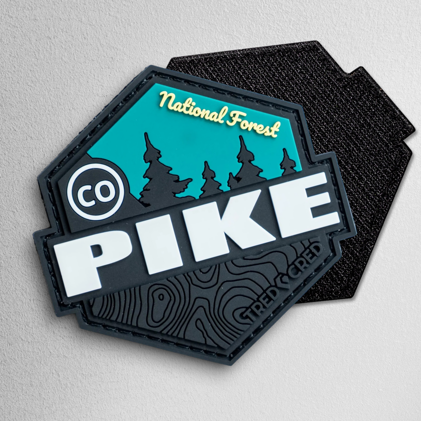 Tred Cred Pike National Forest hexagonal PVC patch with black, teal, and white topographic design.