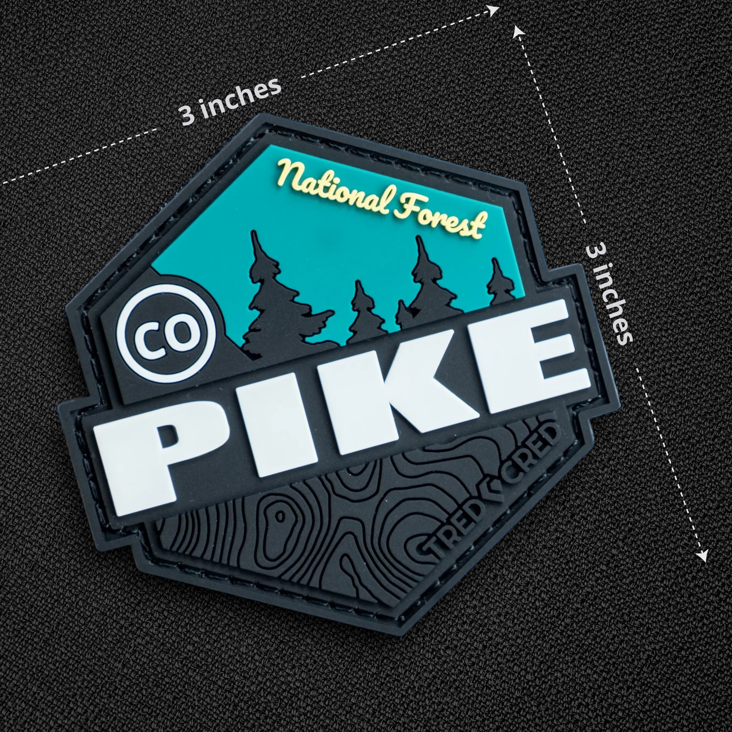Tred Cred Pike National Forest PVC patch with teal, black, and white design, hook and loop backing, 3x3 inch size.