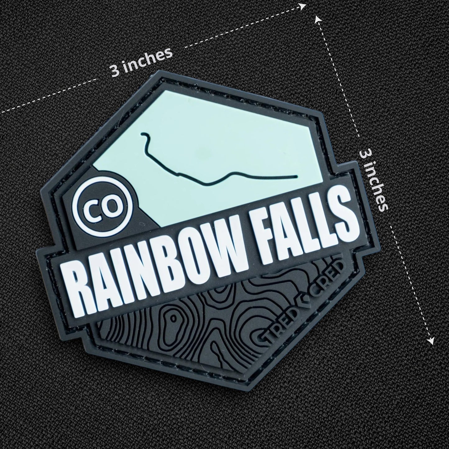 Tred Cred Rainbow Falls PVC trail patch with a hexagonal design, topographic map details, and hook and loop backing.