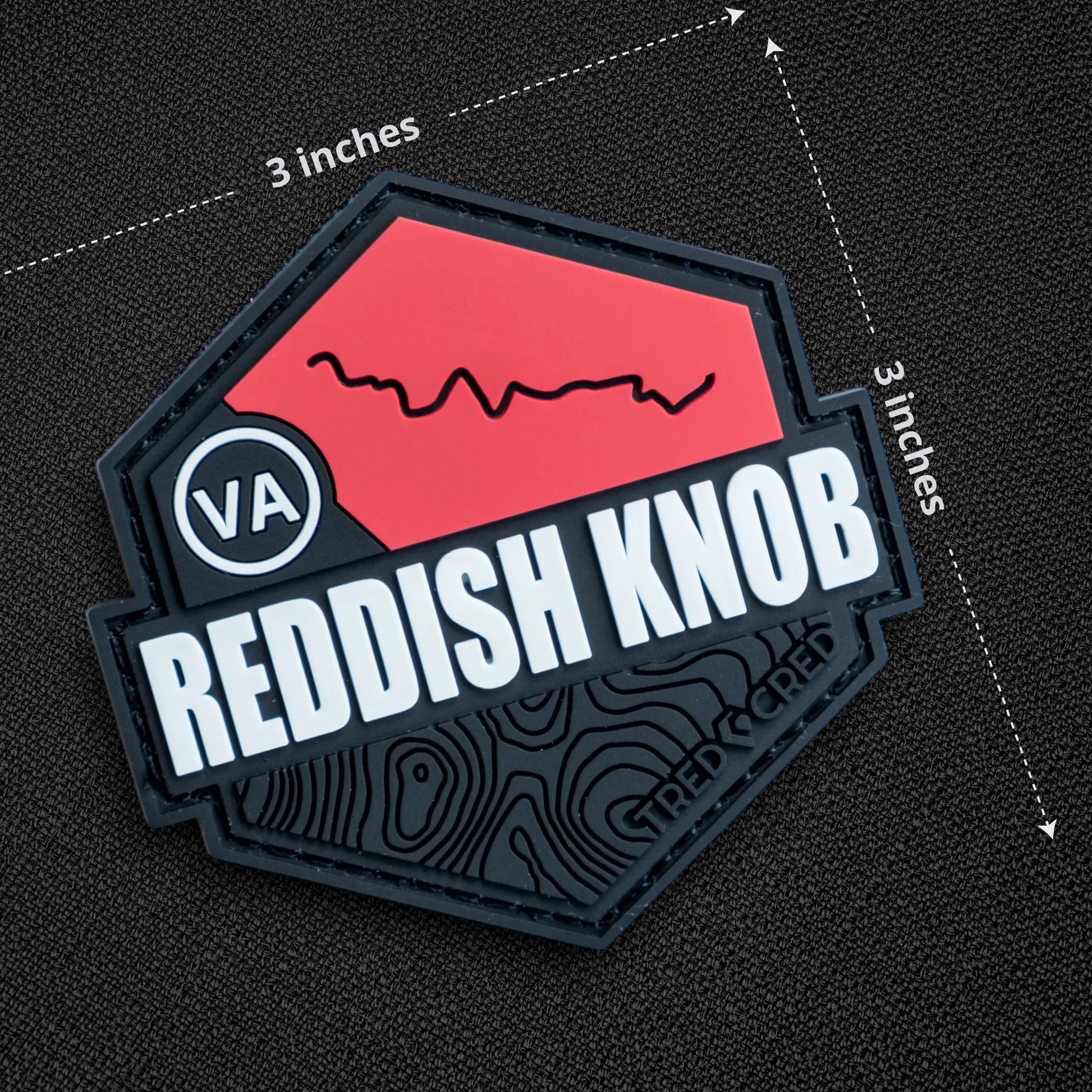 Tred Cred Reddish Knob trail patch in red and black PVC rubber with a hook and loop backing for off-road gear.