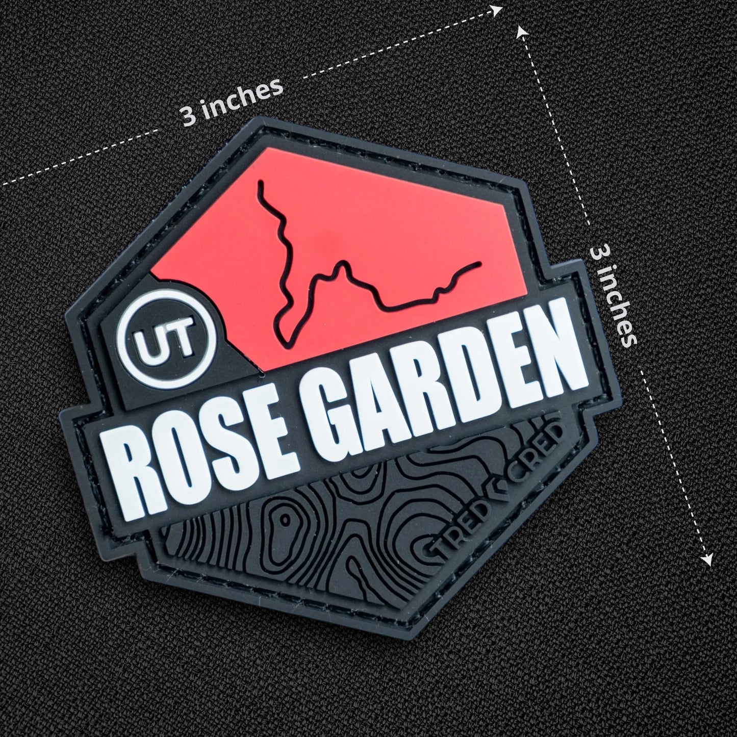 Tred Cred Rose Garden Hill trail patch in red and black PVC rubber with hook and loop backing for off-road gear.