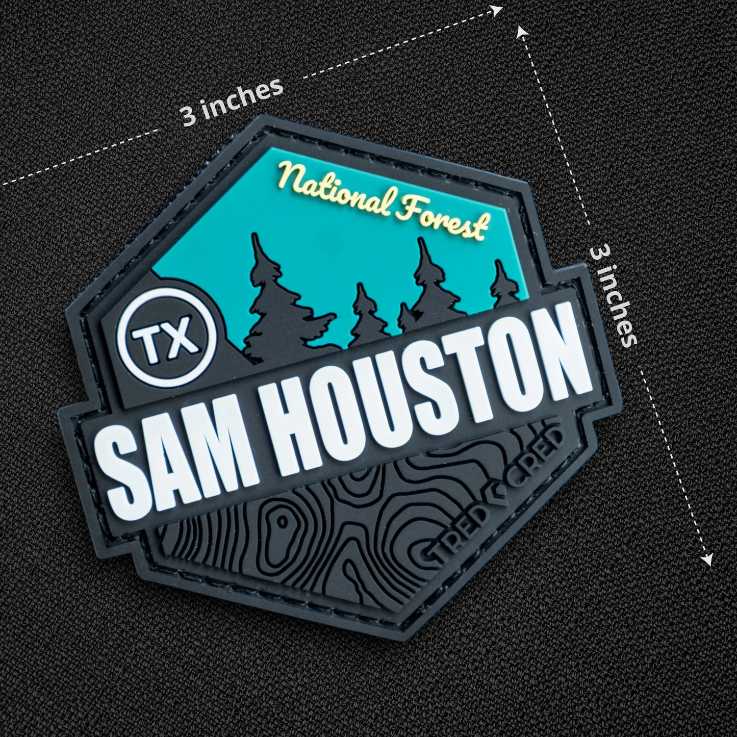 Tred Cred Sam Houston National Forest PVC patch with teal and black topographic design and hook and loop backing