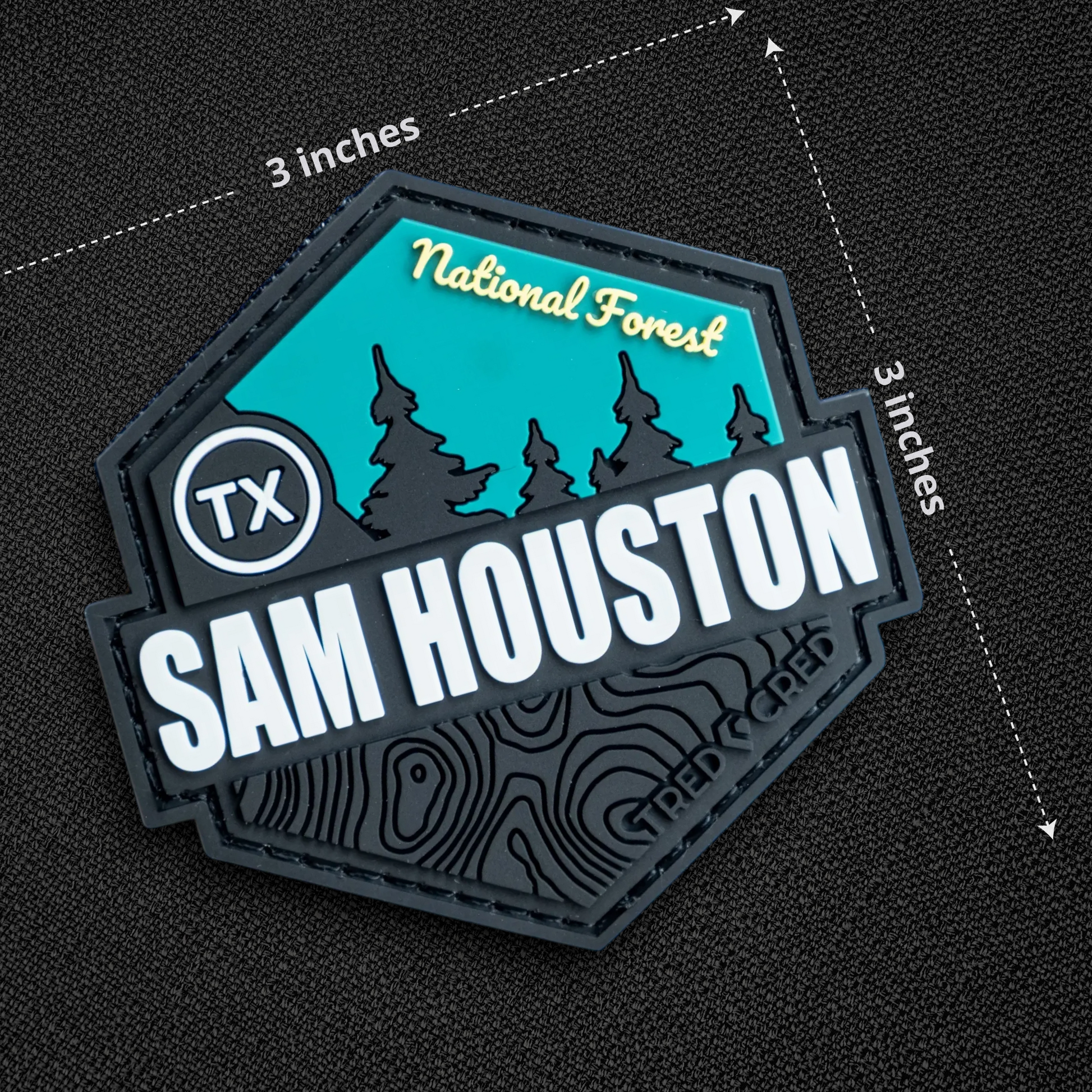Tred Cred Sam Houston National Forest PVC patch with teal and black topographic design and hook and loop backing