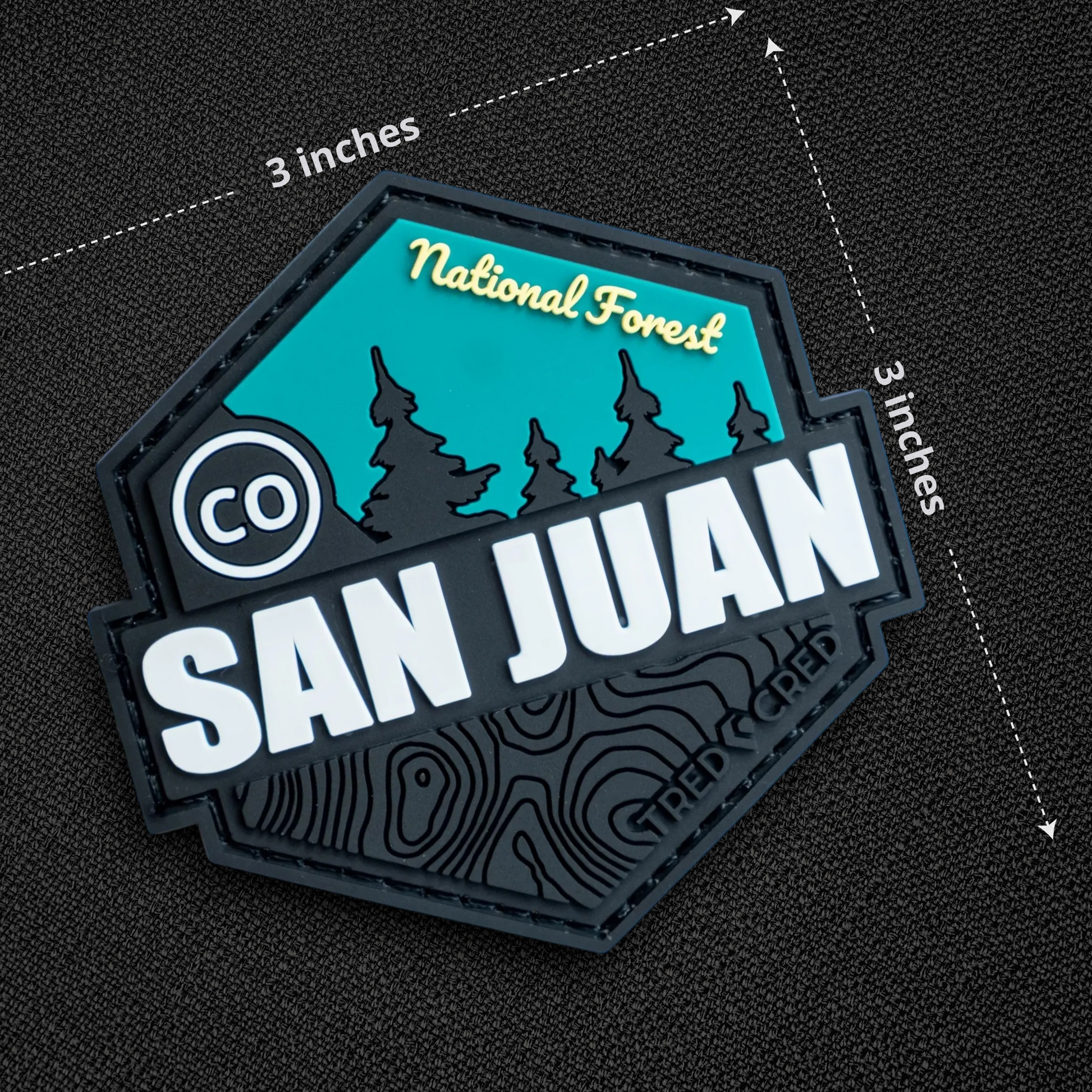 Tred Cred San Juan National Forest PVC patch with teal and black mountain design and hook and loop backing