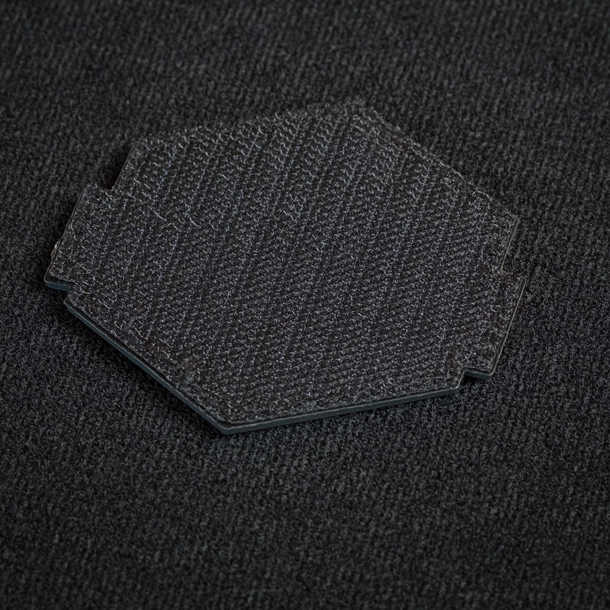 Tred Cred Sierra National Forest patch showing the black hook and loop backing on a dark fabric surface.