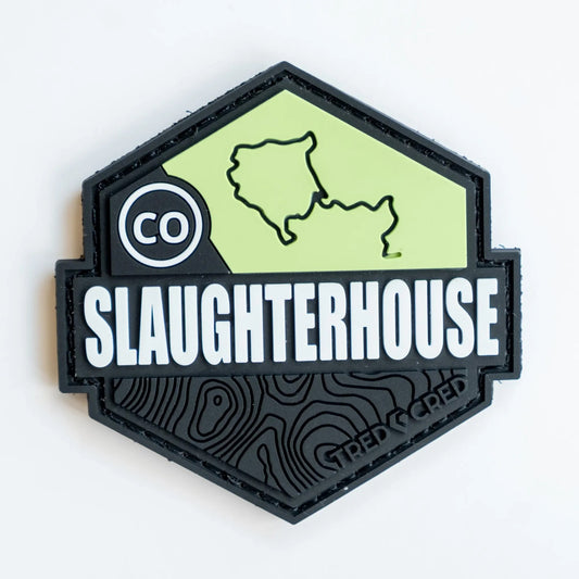 Tred Cred Slaughterhouse trail patch in black and lime green PVC rubber with a Colorado map and topographic design.