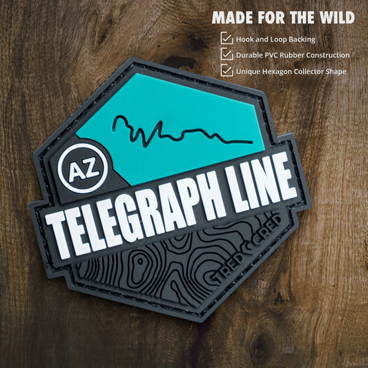 Tred Cred Telegraph Line PVC trail patch with teal and black topographic design and hook and loop backing