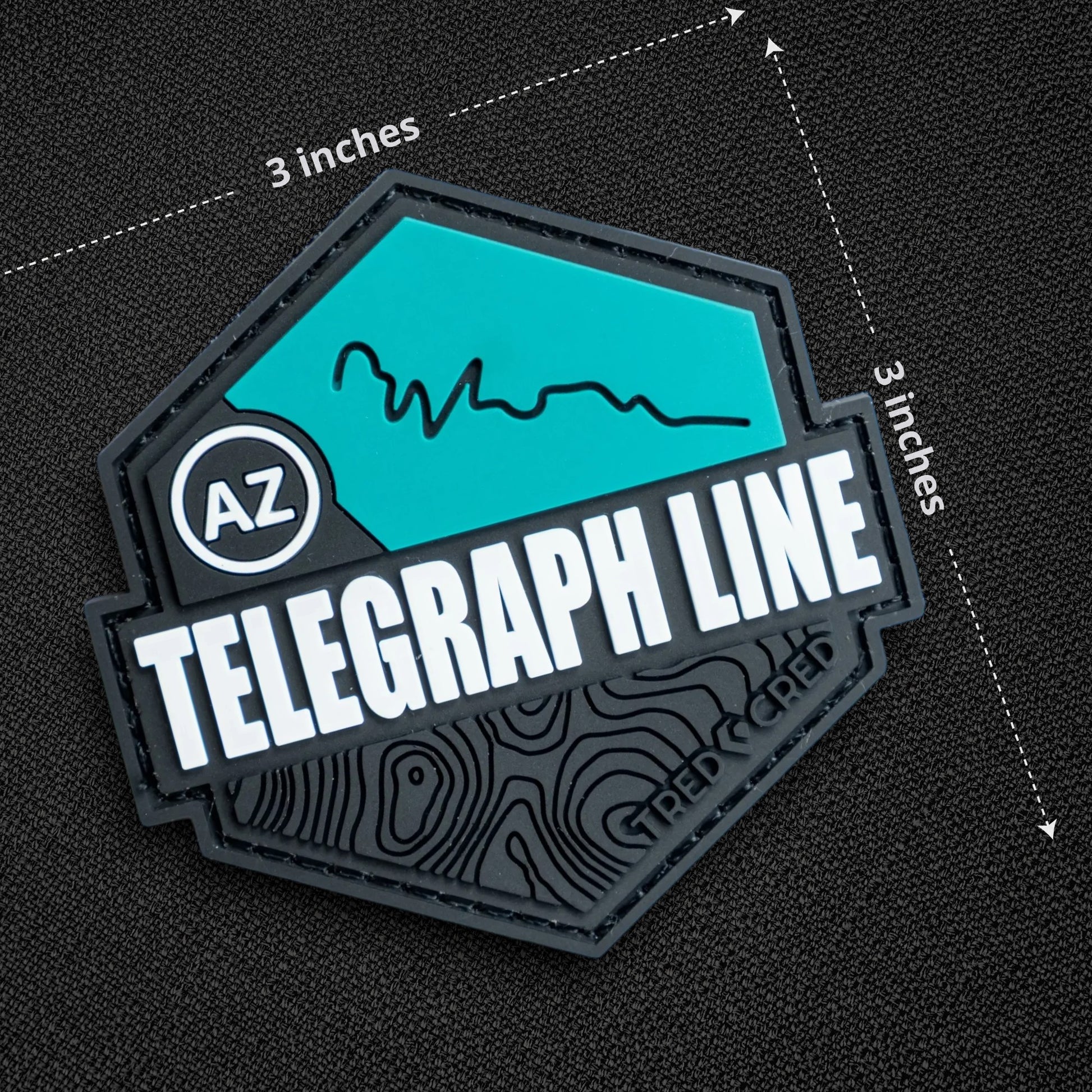 Tred Cred Telegraph Line trail patch in teal and black PVC rubber with AZ badge and hook and loop backing.