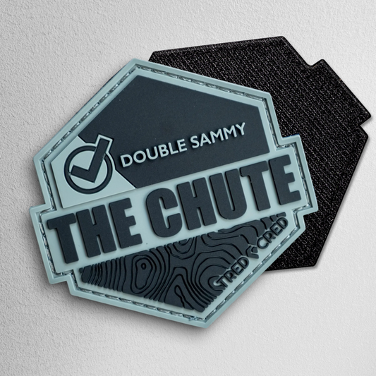 Tred Cred The Chute hexagonal PVC trail patch in grey and black with hook and loop backing.