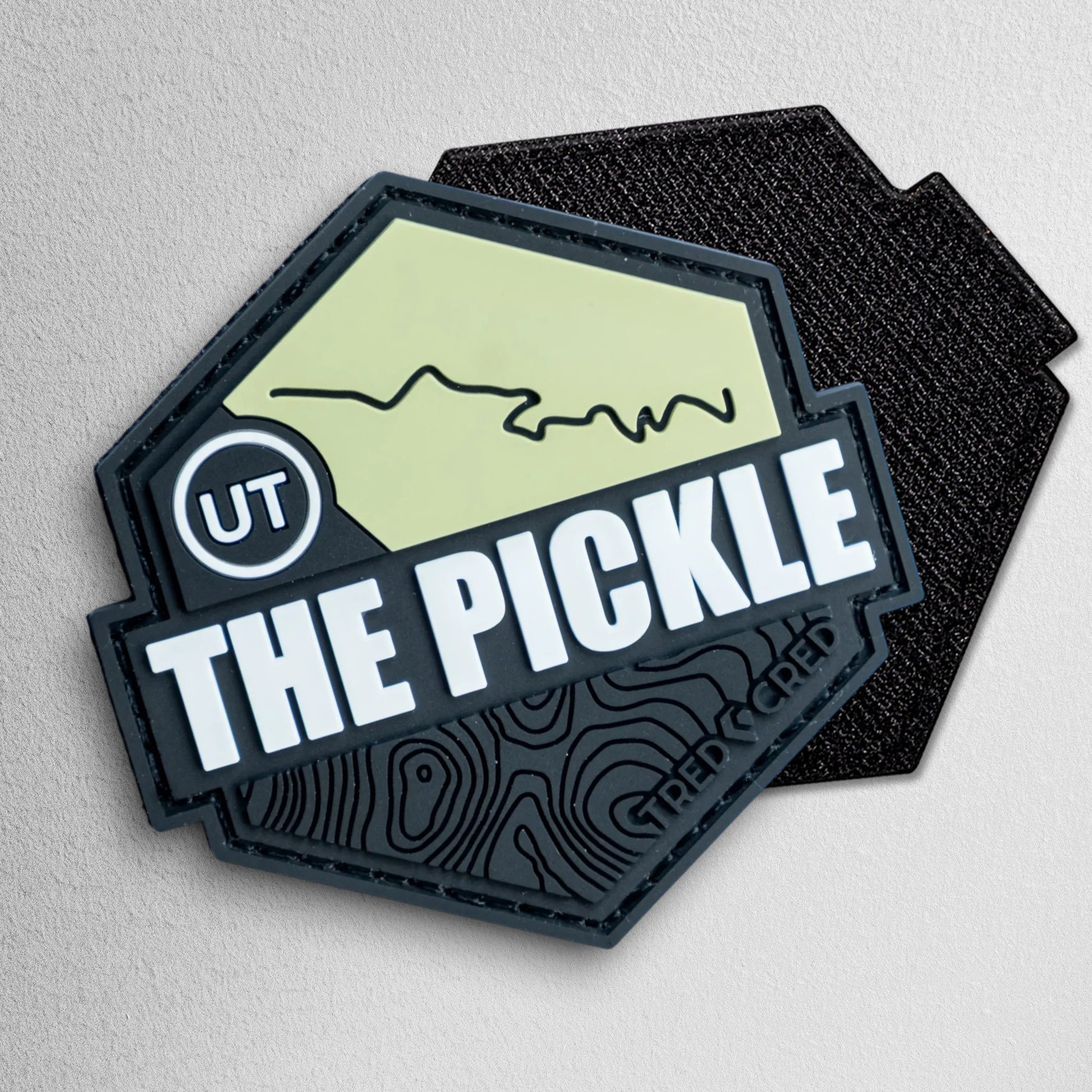 Tred Cred The Pickle hexagonal PVC trail patch with Utah map design and topographic details on a white background.