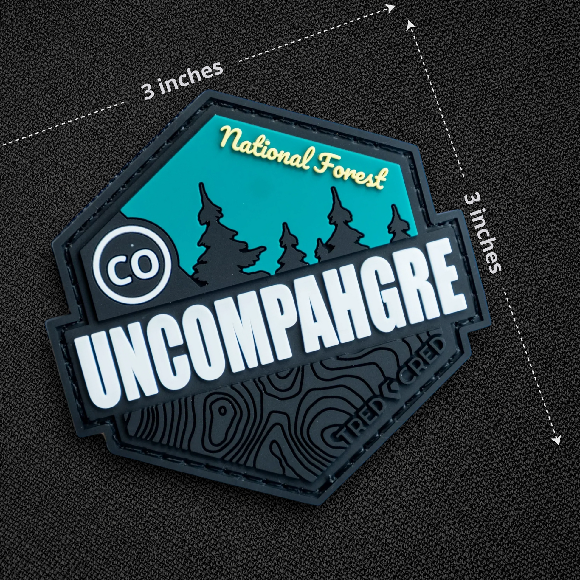 Tred Cred Uncompahgre National Forest PVC patch with teal and black design, featuring topographic map details.